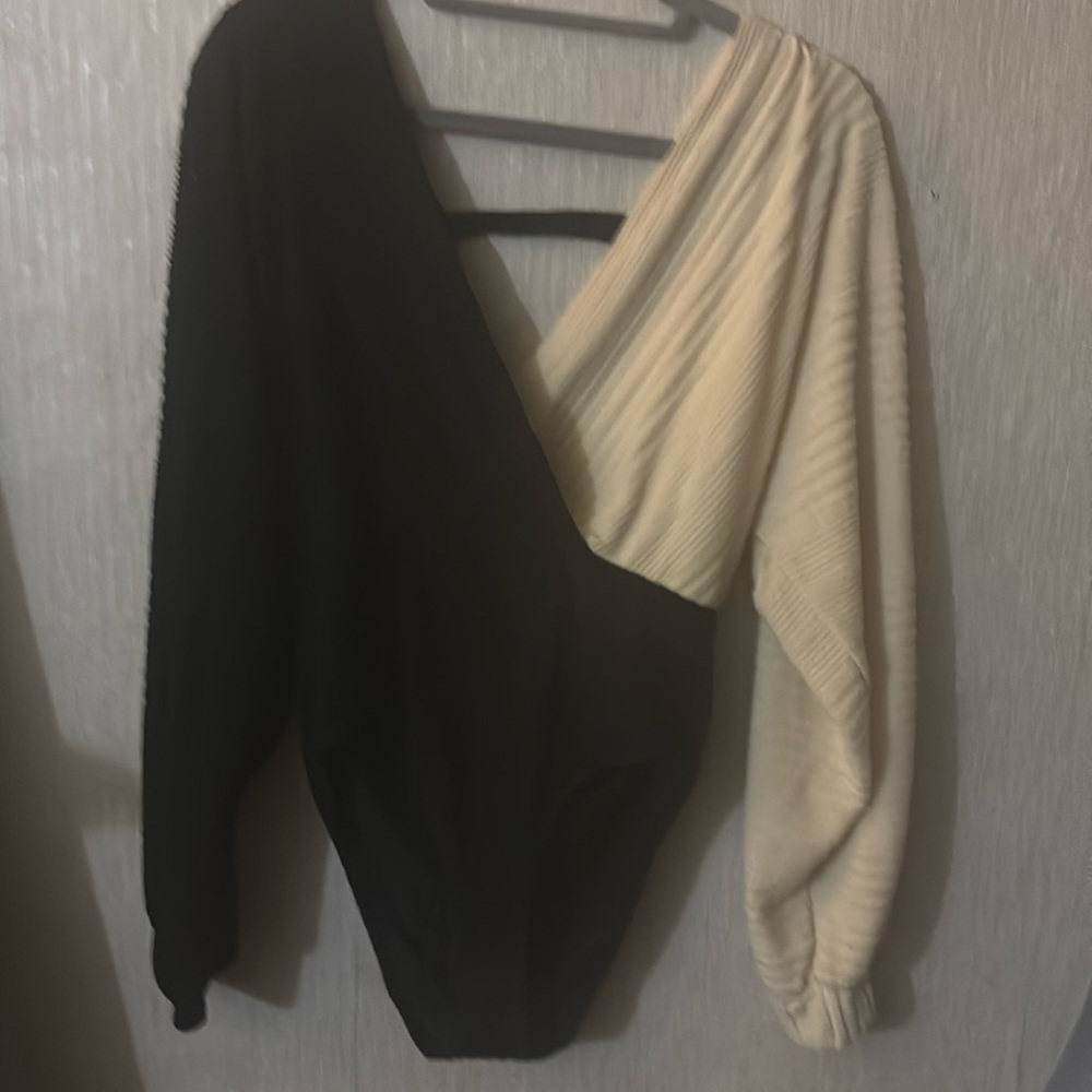 Black and cream colored body suit never been worn. Low v neck with cut out back